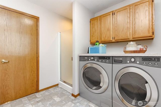 25171 13th Ave S, Des Moines, WA 98198 - laundry room featuring washing machine and clothes dryer, baseboards, and cabinet space