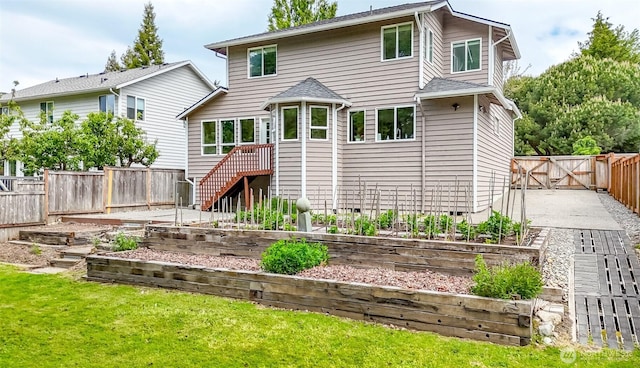25171 13th Ave S, Des Moines, WA 98198 - rear view of property with a vegetable garden, crawl space, a gate, and stairway