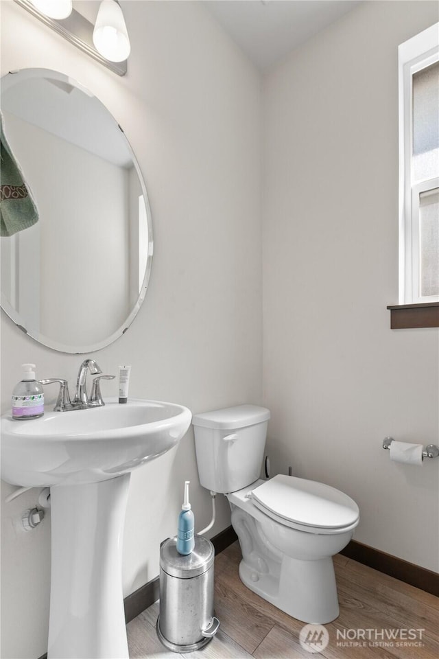 17431 3rd Ave SE, Bothell, WA 98012 - half bathroom featuring baseboards, wood finished floors, toilet, and a sink