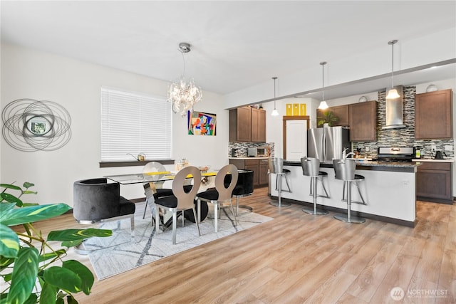 17431 3rd Ave SE, Bothell, WA 98012 - dining area featuring light wood finished floors and a chandelier