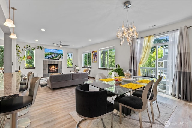 17431 3rd Ave SE, Bothell, WA 98012 - dining area with plenty of natural light, light wood-type flooring, recessed lighting, a tile fireplace, and a chandelier