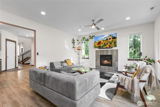 17431 3rd Ave SE, Bothell, WA 98012 - living area with healthy amount of natural light, wood finished floors, a tiled fireplace, and recessed lighting