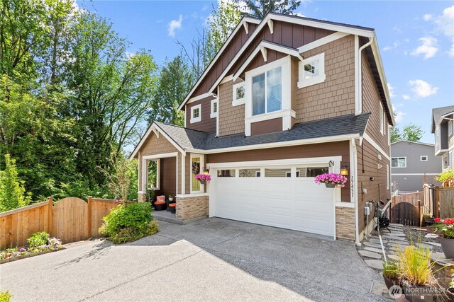 17431 3rd Ave SE, Bothell, WA 98012 - craftsman inspired home with an attached garage, stone siding, concrete driveway, and a gate