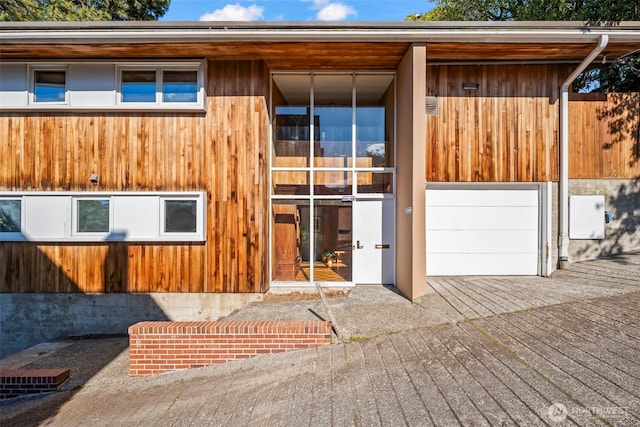 back of house with a garage