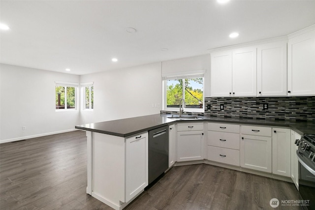 2734 Thornhill Rd SE, Puyallup, WA 98374 - kitchen featuring dishwashing machine, a sink, dark wood finished floors, dark countertops, and recessed lighting