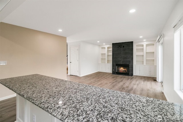 2734 Thornhill Rd SE, Puyallup, WA 98374 - unfurnished living room with wood finished floors, baseboards, a fireplace, and recessed lighting