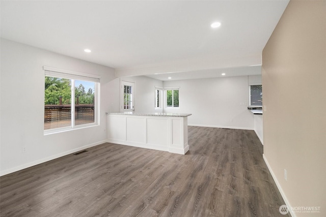 2734 Thornhill Rd SE, Puyallup, WA 98374 - kitchen with plenty of natural light, recessed lighting, dark wood-style floors, baseboards, and light stone countertops