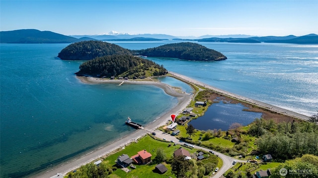 drone / aerial view featuring a water and mountain view