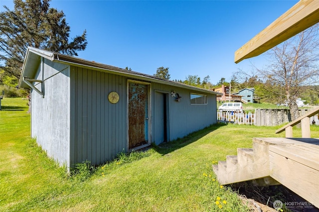 view of property exterior with fence and a yard