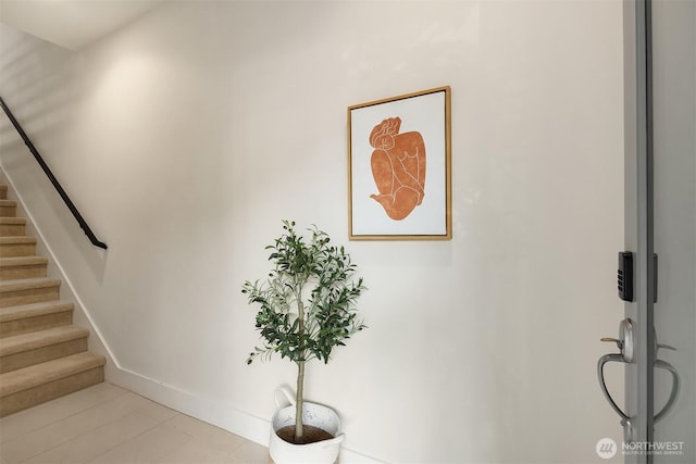 staircase featuring baseboards