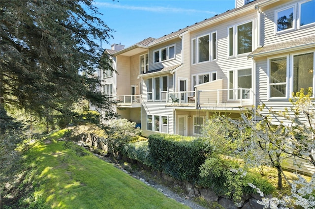 9821 NE Riverbend Dr Unit C102, Bothell, WA 98011 - rear view of house featuring a chimney and a yard