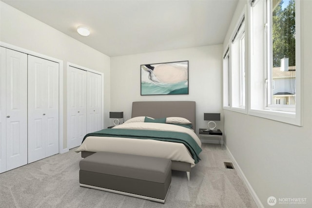 9821 NE Riverbend Dr Unit C102, Bothell, WA 98011 - carpeted bedroom featuring two closets and baseboards
