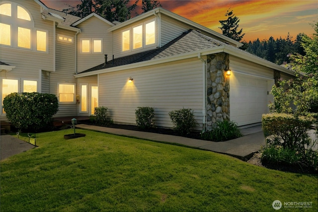 9821 NE Riverbend Dr Unit C102, Bothell, WA 98011 - view of front of house featuring a lawn, an attached garage, a shingled roof, and stone siding