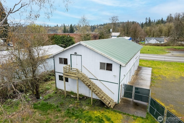228 S 3rd St, Shelton, WA 98584 - rear view of property with fence, stairs, and metal roof