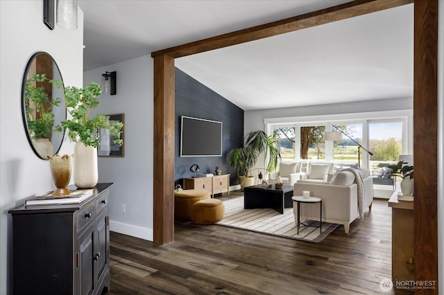 living area with vaulted ceiling with beams, baseboards, and dark wood-type flooring