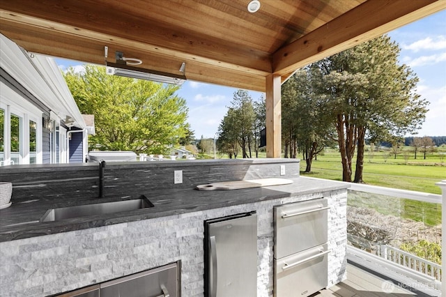 view of patio with a sink and area for grilling