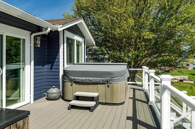 wooden terrace featuring a hot tub