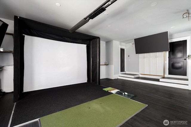 playroom with golf simulator and wood finished floors