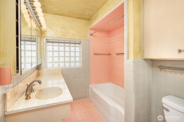 5429 NE Windermere Rd, Seattle, WA 98105 - bathroom with tile walls, tile patterned floors, vanity, toilet, and shower / bathtub combination