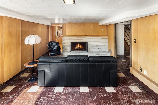 5429 NE Windermere Rd, Seattle, WA 98105 - living area with stairs, tile patterned floors, wood walls, and a fireplace