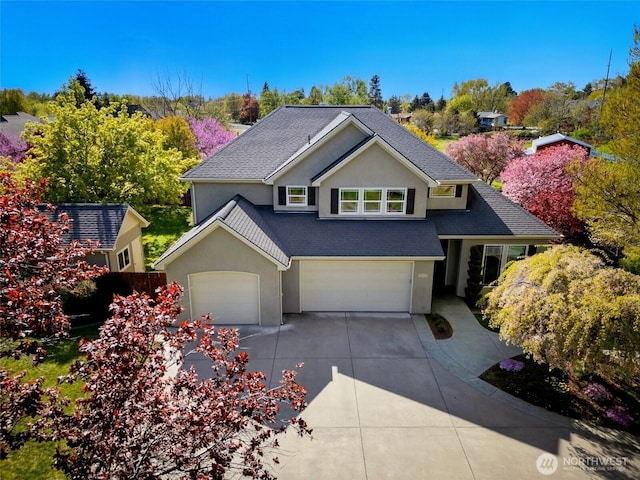 162 Costello Pl, Walla Walla, WA 99362 - view of front of house featuring an attached garage, concrete driveway, stucco siding, and roof with shingles