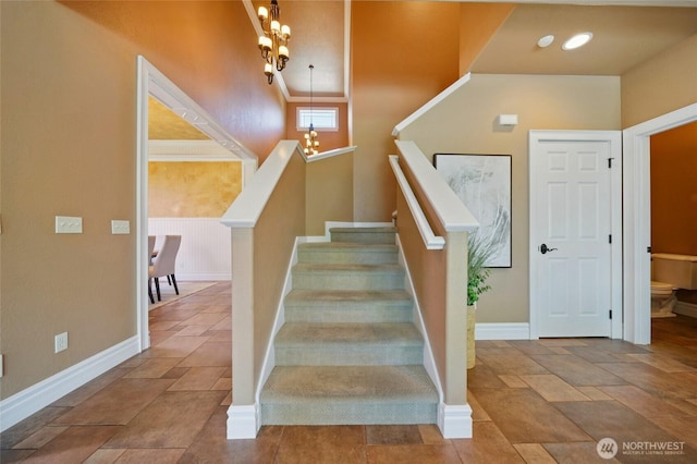 162 Costello Pl, Walla Walla, WA 99362 - stairs featuring an inviting chandelier, stone tile flooring, and baseboards