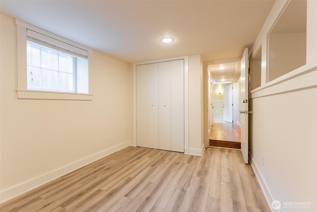 unfurnished bedroom with light wood finished floors, baseboards, recessed lighting, and a closet