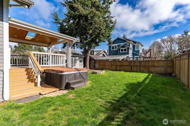 view of yard featuring a shed, a deck, a fenced backyard, an outbuilding, and a hot tub