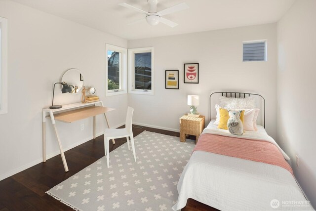 bedroom featuring wood finished floors, baseboards, and a ceiling fan