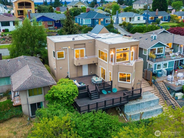 rear view of property with a residential view and a wooden deck