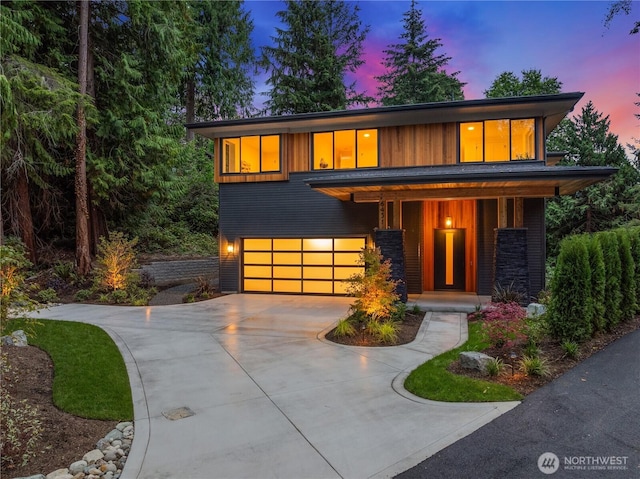 view of front of property with an attached garage, a porch, and concrete driveway