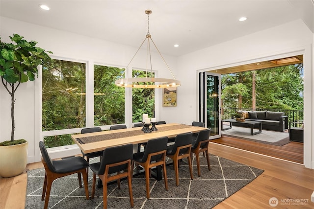 dining space featuring wood finished floors and recessed lighting