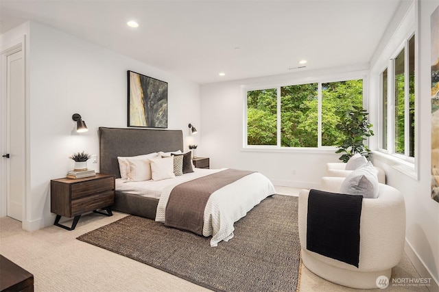 carpeted bedroom featuring baseboards and recessed lighting