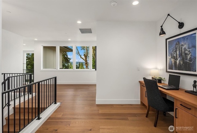 office featuring recessed lighting, visible vents, light wood finished floors, and baseboards