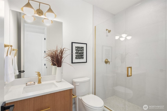 full bath with vanity, toilet, and a stall shower