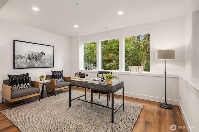 office featuring visible vents, baseboards, wood finished floors, and recessed lighting