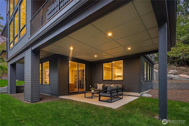 rear view of property with a yard, outdoor lounge area, and a patio area