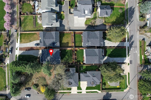 birds eye view of property with a residential view