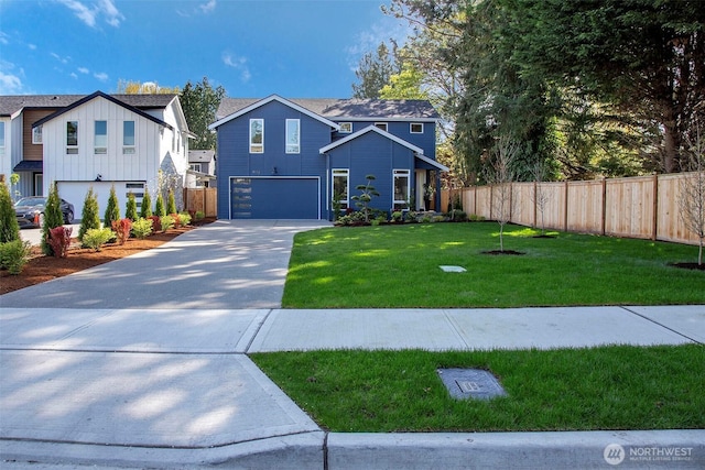 view of front of property with fence, a front lawn, board and batten siding, driveway, and a garage