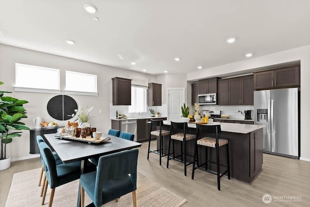 dining area featuring recessed lighting and light wood-style flooring