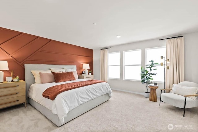 bedroom featuring baseboards and light colored carpet