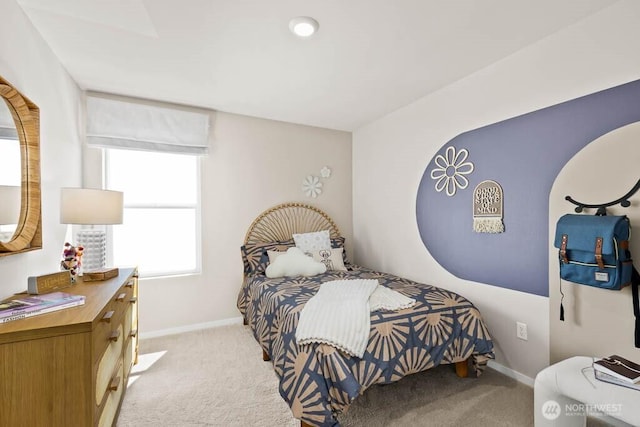 bedroom featuring baseboards and carpet