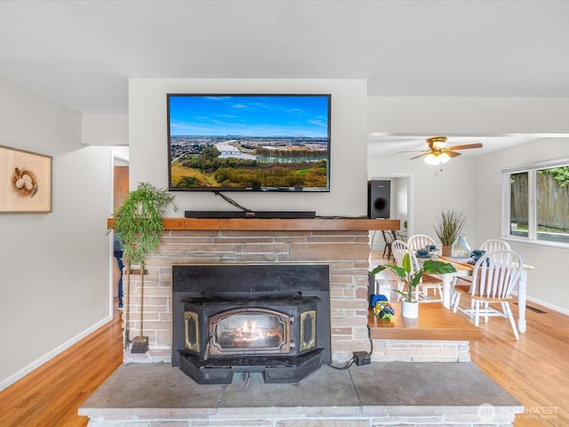 4913 W View Dr, Everett, WA 98203 - living room with a wood stove, wood finished floors, and ceiling fan