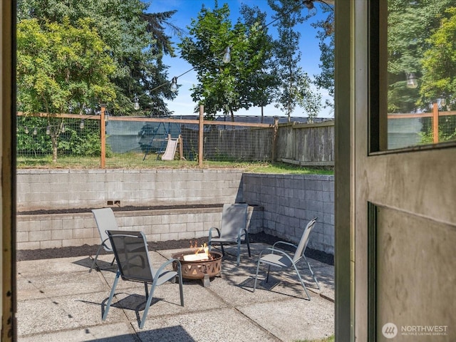 4913 W View Dr, Everett, WA 98203 - fenced backyard featuring a fire pit and a patio area