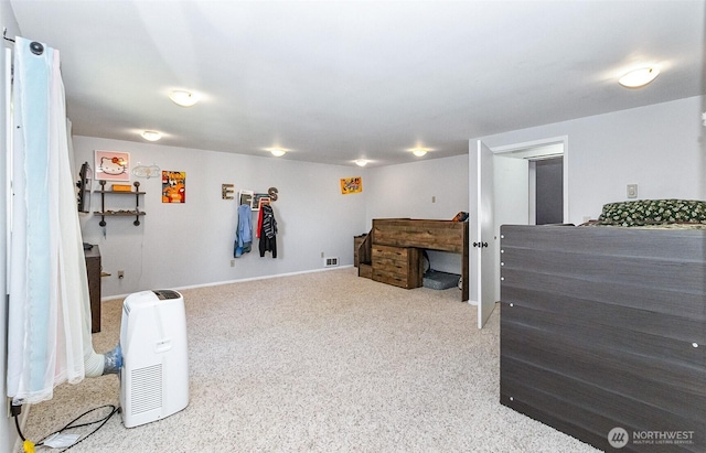 interior space featuring visible vents, baseboards, and carpet floors