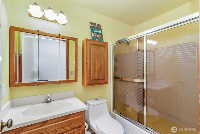 full bathroom with toilet and vanity