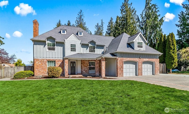 view of front of house with a front lawn, board and batten siding, a chimney, concrete driveway, and fence