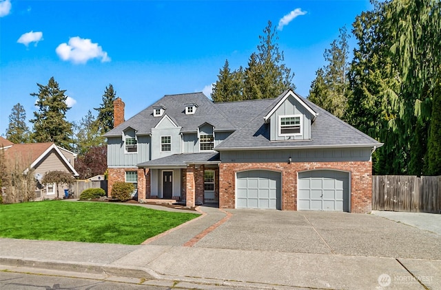 view of front of house with brick siding, fence, a garage, driveway, and a front lawn