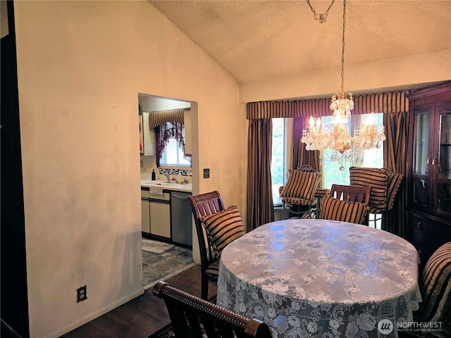 dining area featuring a chandelier, vaulted ceiling, dark wood-style floors, and a textured ceiling