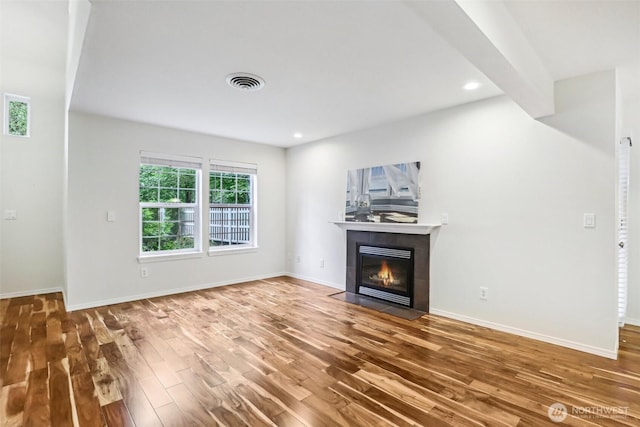 17200 SE 26th Dr Unit P56, Vancouver, WA 98683 - unfurnished living room featuring wood finished floors, healthy amount of natural light, a tiled fireplace, baseboards, and recessed lighting